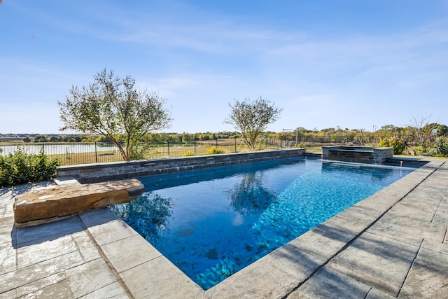 view of swimming pool with an in ground hot tub and a water view