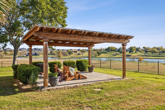 view of yard with a pergola, a water view, and a patio