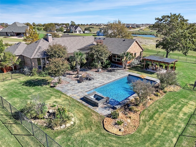 view of swimming pool with a yard, a patio area, and an in ground hot tub