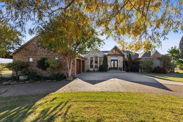 view of front of house featuring a garage and a front lawn