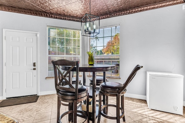 tiled dining room with a notable chandelier