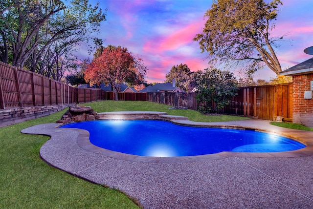 pool at dusk featuring a yard