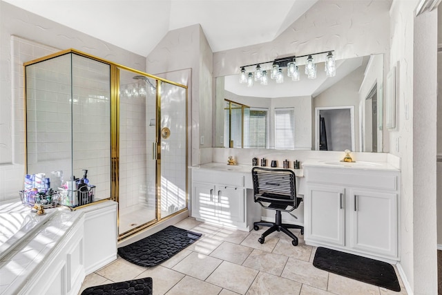 bathroom with tile patterned floors, a shower with door, vanity, and vaulted ceiling