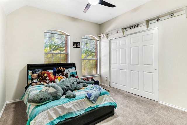 bedroom featuring ceiling fan, a closet, and light colored carpet