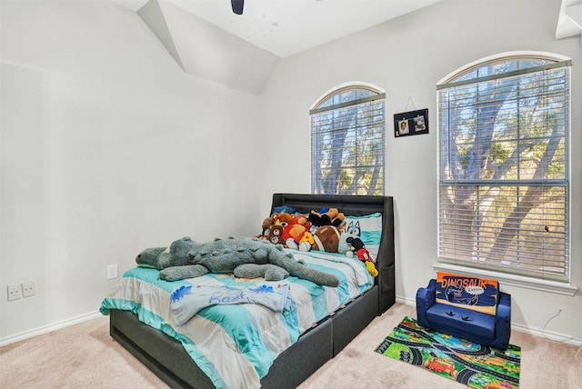 carpeted bedroom featuring multiple windows, ceiling fan, and lofted ceiling