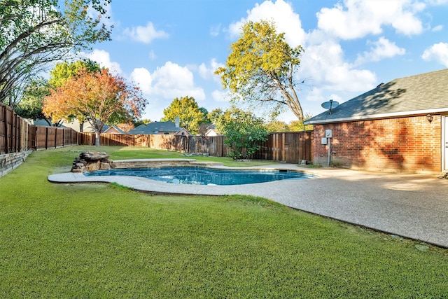 view of pool with a lawn