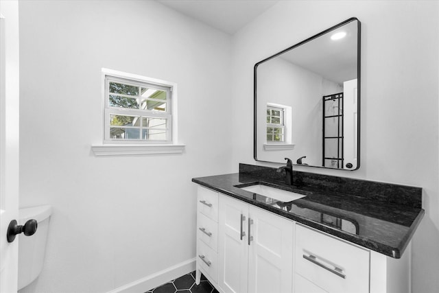 bathroom featuring vanity and toilet