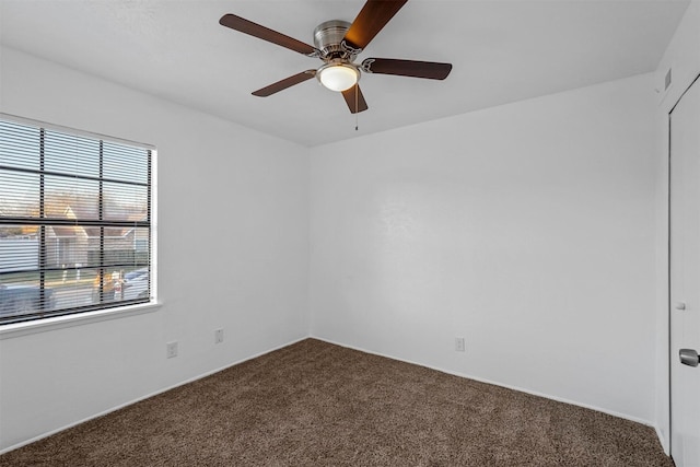 unfurnished room with ceiling fan and carpet