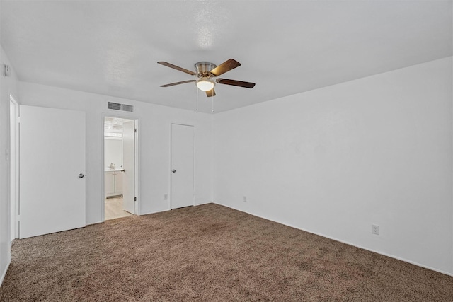 unfurnished bedroom featuring ceiling fan, a closet, and carpet