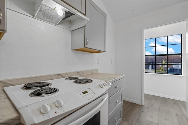 kitchen featuring ventilation hood, gray cabinets, white range with electric stovetop, and light hardwood / wood-style floors