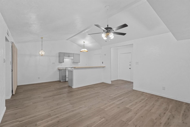 unfurnished living room featuring ceiling fan, hardwood / wood-style floors, and lofted ceiling