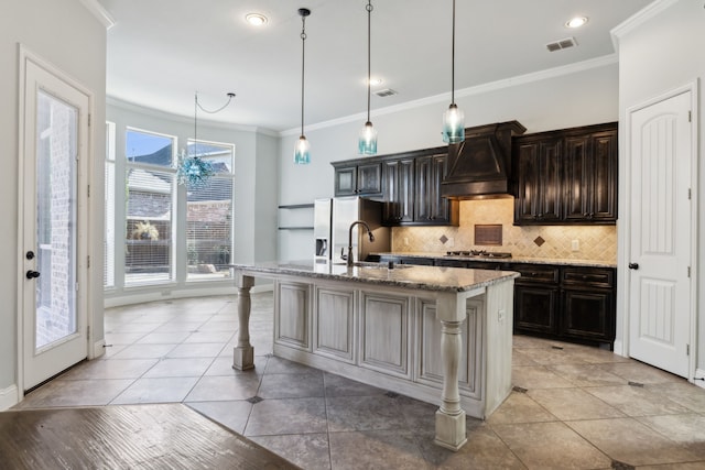 kitchen with an island with sink, stainless steel appliances, stone counters, a breakfast bar, and custom exhaust hood