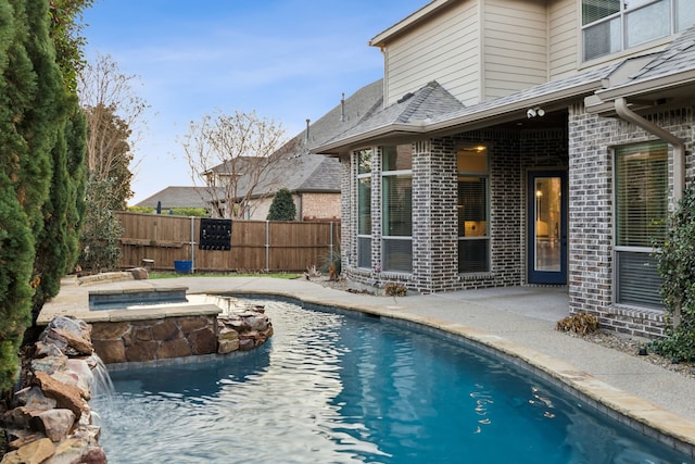 view of pool featuring a patio area and an in ground hot tub