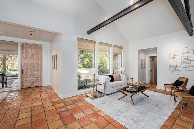 tiled living room with beamed ceiling, high vaulted ceiling, and a wealth of natural light