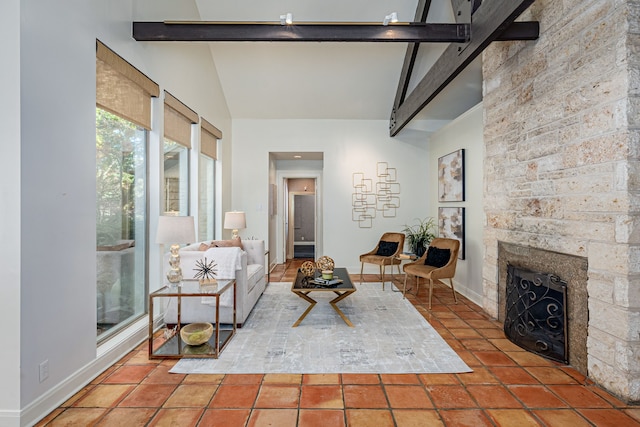 unfurnished living room featuring a large fireplace, beam ceiling, and high vaulted ceiling