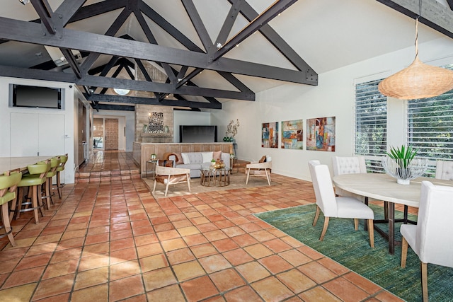 tiled dining area with beamed ceiling and high vaulted ceiling