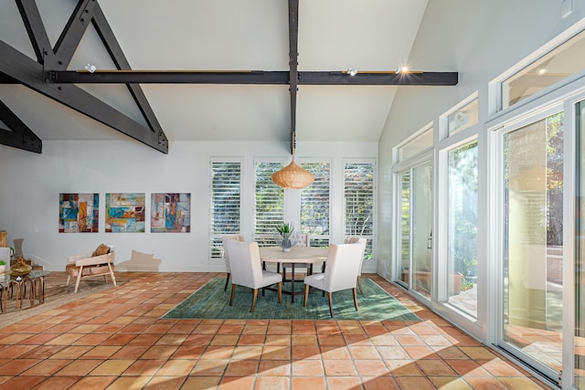 sunroom / solarium featuring lofted ceiling with beams and a wealth of natural light