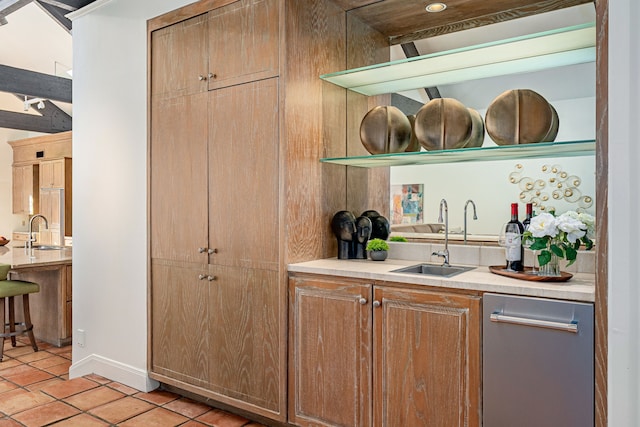 bar featuring light tile patterned floors and sink