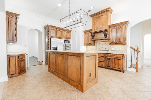 kitchen with a center island, light tile patterned floors, stainless steel appliances, and a notable chandelier