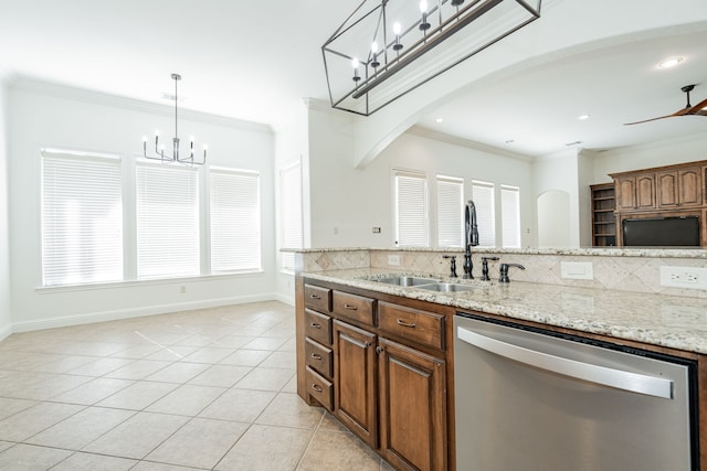 kitchen featuring a wealth of natural light, light tile patterned floors, stainless steel dishwasher, and ceiling fan with notable chandelier