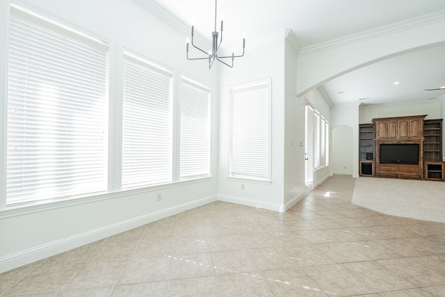 interior space featuring crown molding, light tile patterned flooring, and ceiling fan with notable chandelier