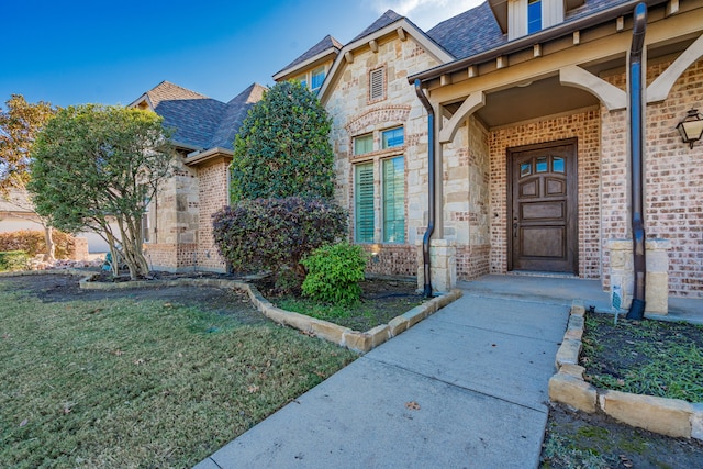 doorway to property featuring a yard