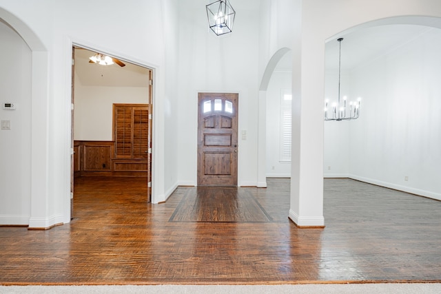 foyer entrance featuring a high ceiling and dark hardwood / wood-style floors