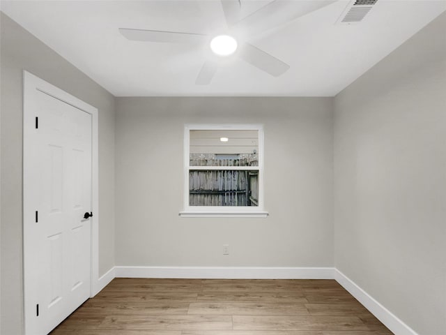 empty room featuring ceiling fan and light hardwood / wood-style floors