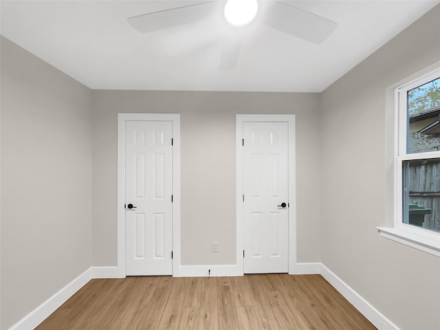 unfurnished bedroom with ceiling fan and light wood-type flooring