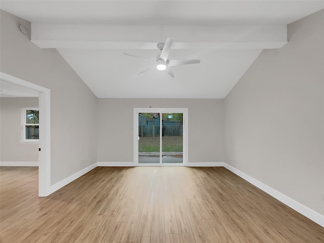 spare room with ceiling fan, light hardwood / wood-style floors, and vaulted ceiling with beams