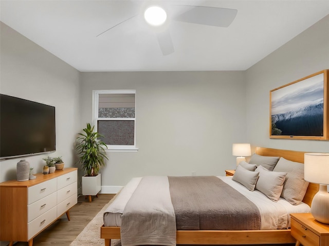 bedroom with ceiling fan and light wood-type flooring