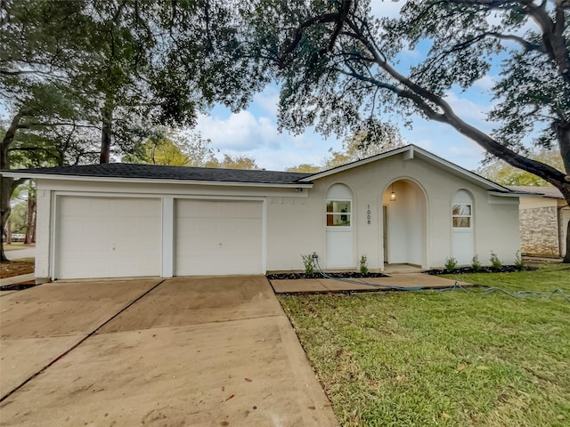 ranch-style home featuring a garage and a front lawn