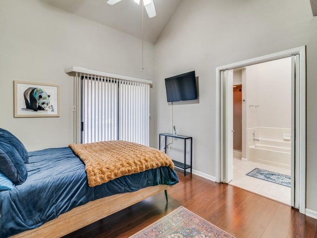 bedroom with hardwood / wood-style flooring, ceiling fan, high vaulted ceiling, and connected bathroom