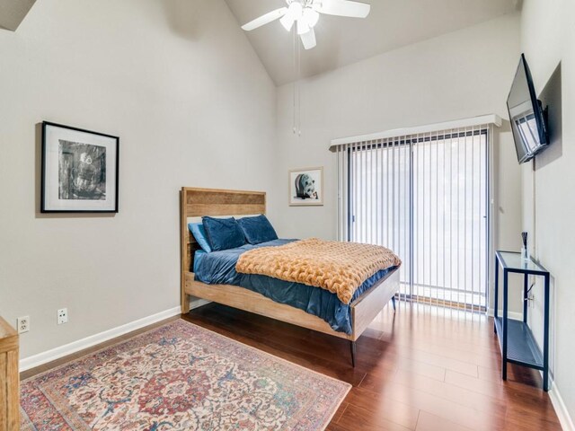 bedroom with ceiling fan, wood-type flooring, and high vaulted ceiling