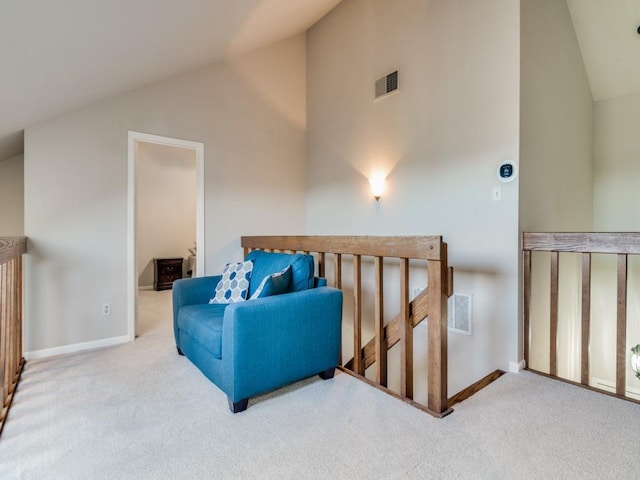 living area featuring carpet and high vaulted ceiling