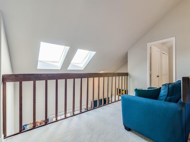 sitting room featuring light carpet and lofted ceiling with skylight