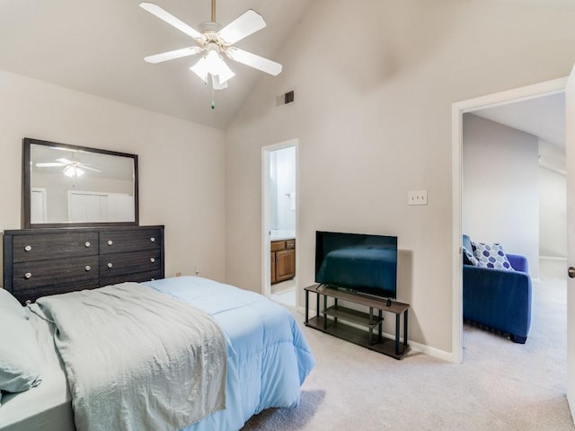 bedroom featuring ceiling fan, light colored carpet, high vaulted ceiling, and ensuite bath