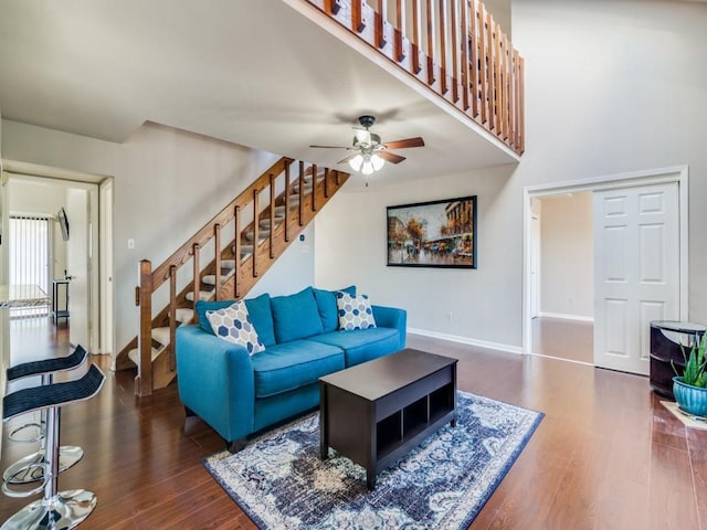 living room with dark hardwood / wood-style floors and ceiling fan