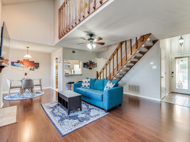 living room with hardwood / wood-style floors and ceiling fan