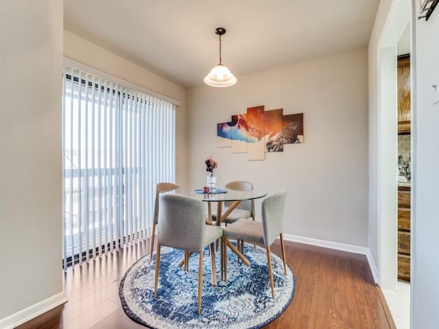 dining space with wood-type flooring