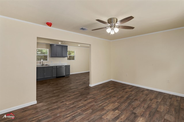 unfurnished living room with ceiling fan, sink, dark wood-type flooring, and ornamental molding