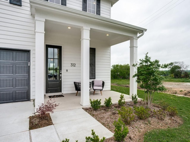 view of exterior entry with covered porch