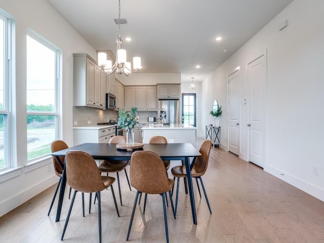 dining room featuring light hardwood / wood-style floors and an inviting chandelier