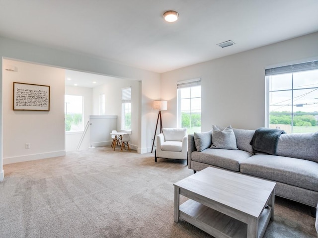 living room featuring carpet and a wealth of natural light