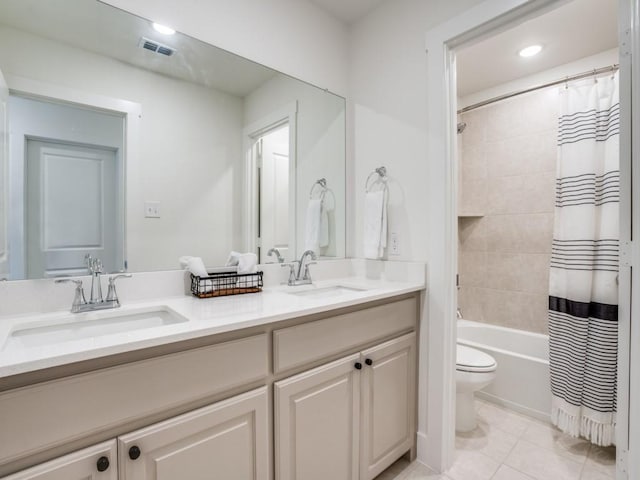 full bathroom with tile patterned flooring, vanity, shower / bath combo, and toilet