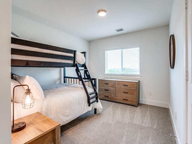 bedroom featuring light carpet