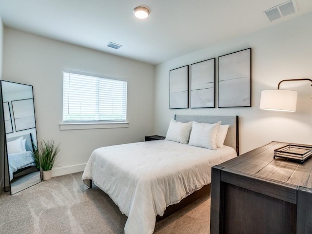 bedroom featuring light colored carpet