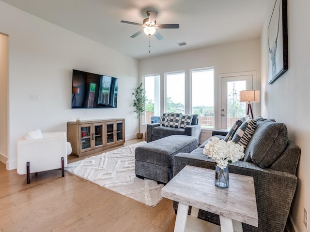 living room featuring light wood-type flooring and ceiling fan