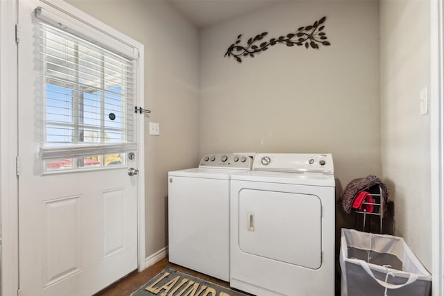 clothes washing area featuring washer and dryer and dark hardwood / wood-style floors