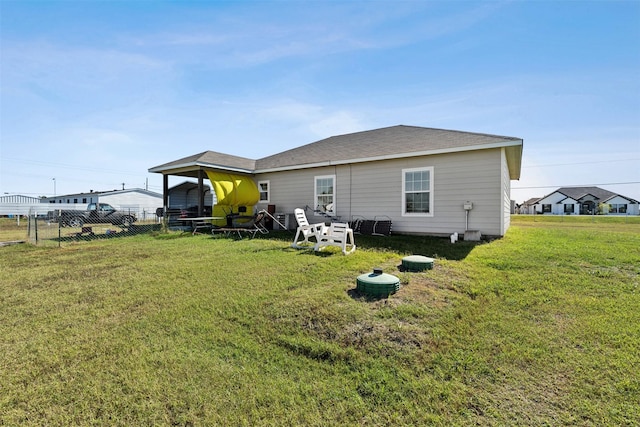 back of house featuring a yard